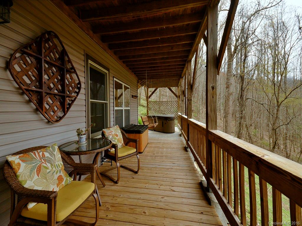 502 Sugar Cove Road Clyde, NC 28721 - Photo 24 of 24 a balcony with wooden furniture and wooden floor