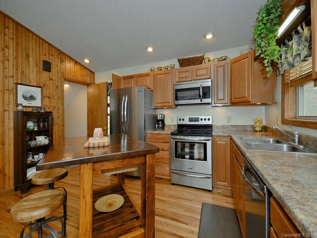 502 Sugar Cove Road Clyde, NC 28721 - Photo 7 of 24 a kitchen with stainless steel appliances granite countertop a stove a sink and a refrigerator