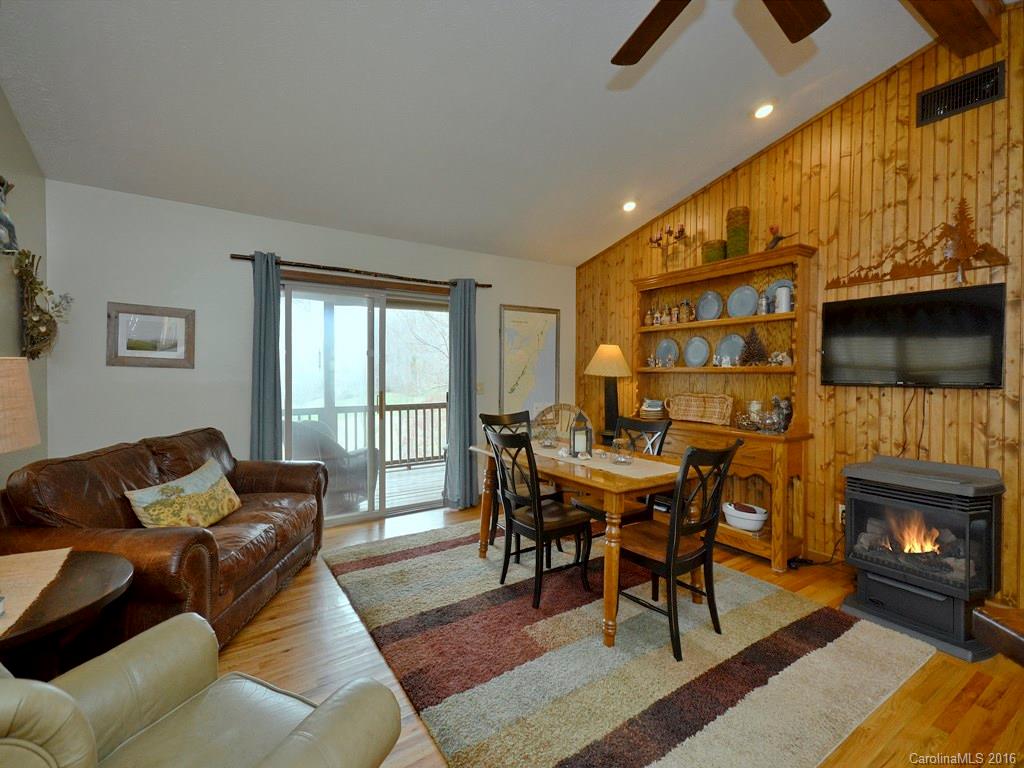 502 Sugar Cove Road Clyde, NC 28721 - Photo 8 of 24 a living room with furniture a flat screen tv and a fireplace