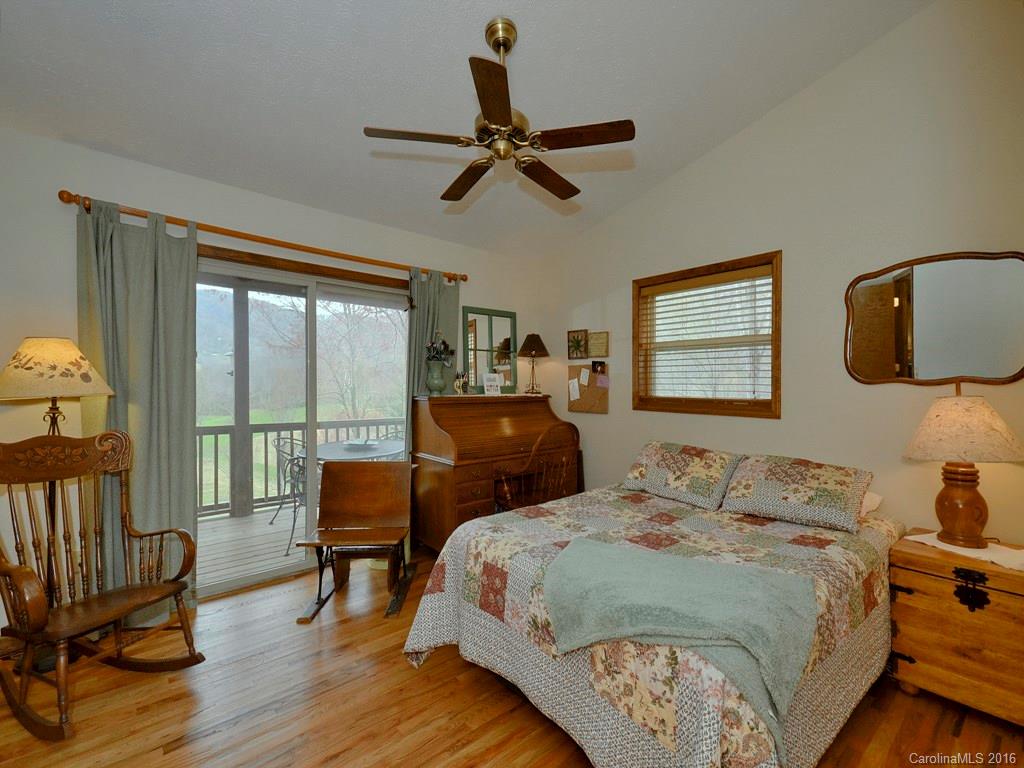 502 Sugar Cove Road Clyde, NC 28721 - Photo 10 of 24 a bedroom with a bed and wooden floor