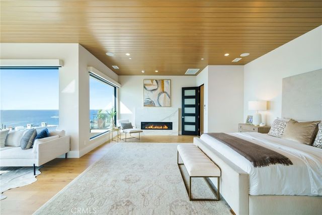 a bedroom with a large bed and a flat screen tv