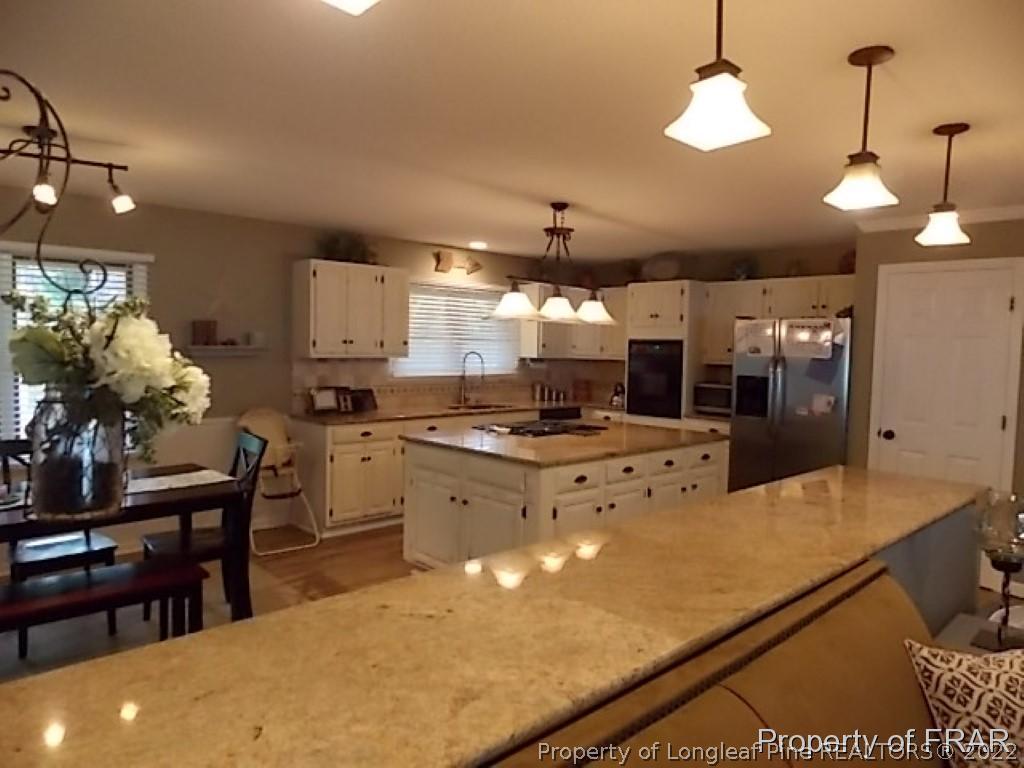 530 Hill Road Southern Pines, NC 28387 - Photo 5 of 25 a large kitchen with lots of counter space and appliances