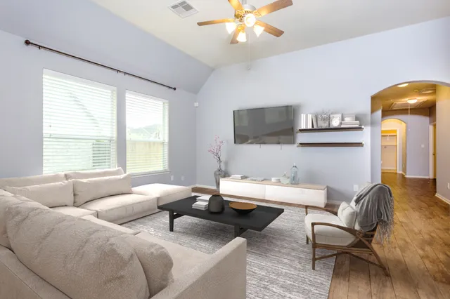 a living room with furniture and a large window