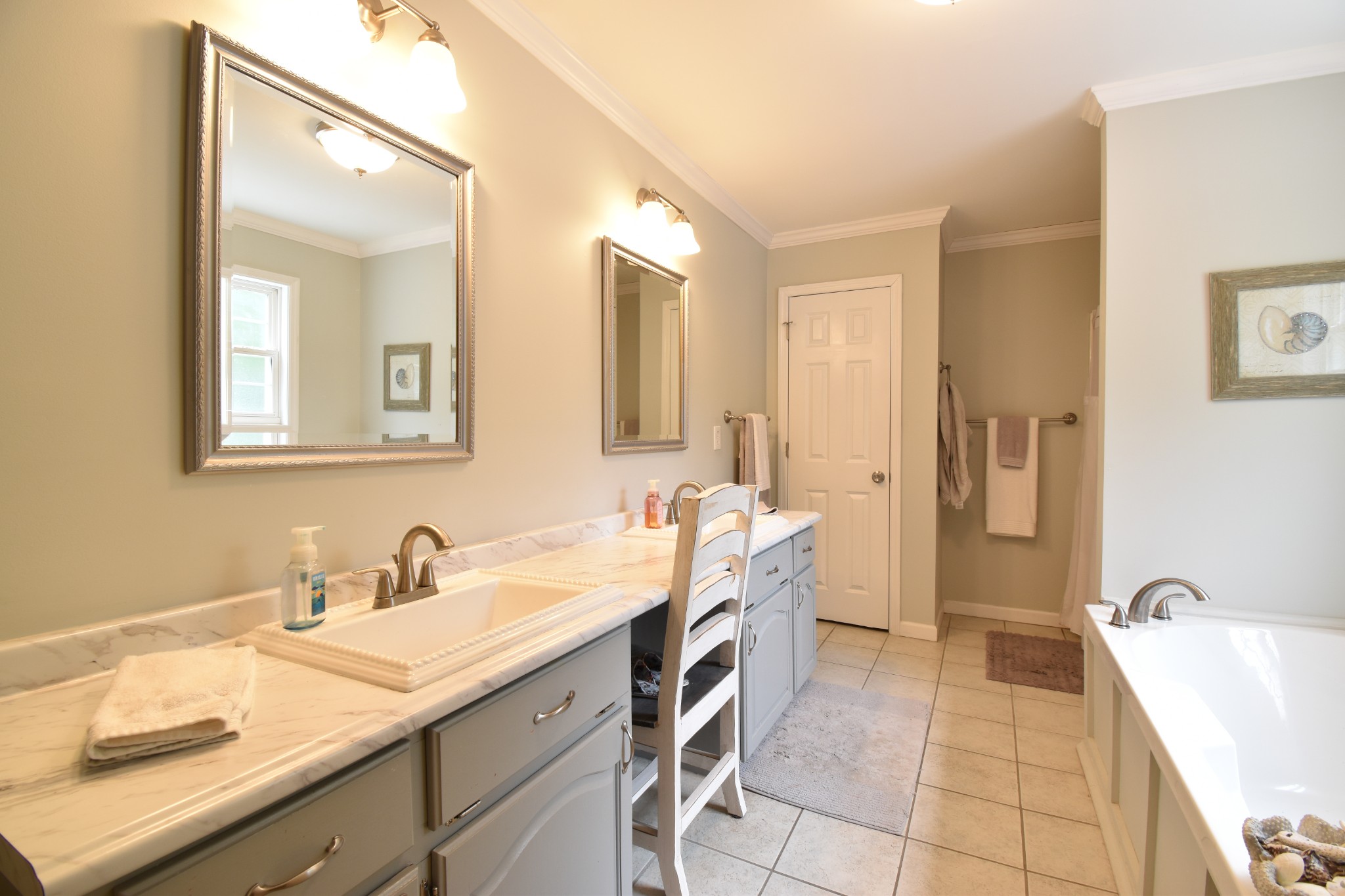1000 Five Points Road Pulaski, TN 38478 - Photo 35 of 50 a spacious bathroom with a double vanity sink a mirror a bathtub and