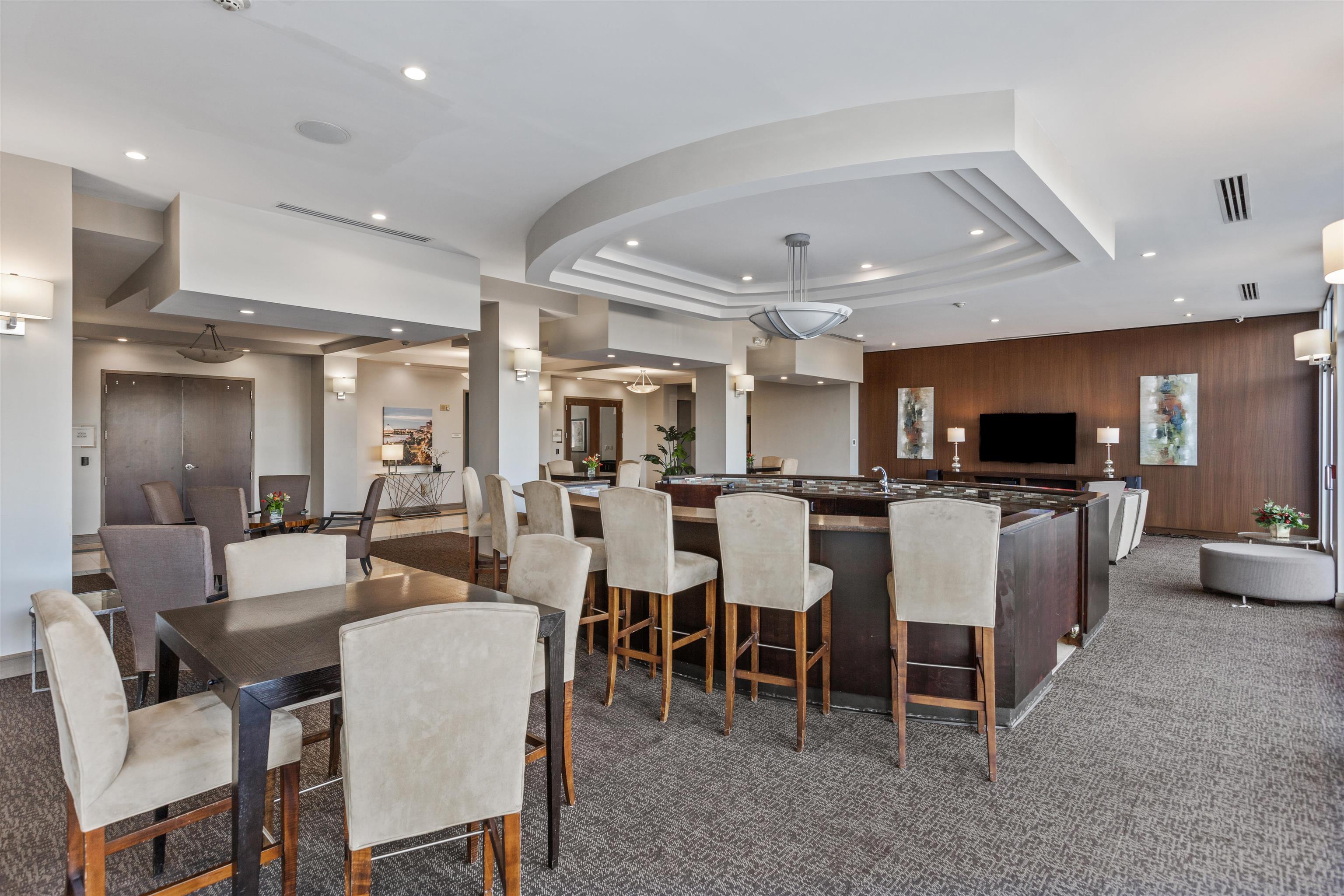 655 Riverside Drive, Unit 1208 Memphis, TN 38103 - Photo 28 of 29 Carpeted dining room featuring recessed lighting, a raised ceiling, and wood walls