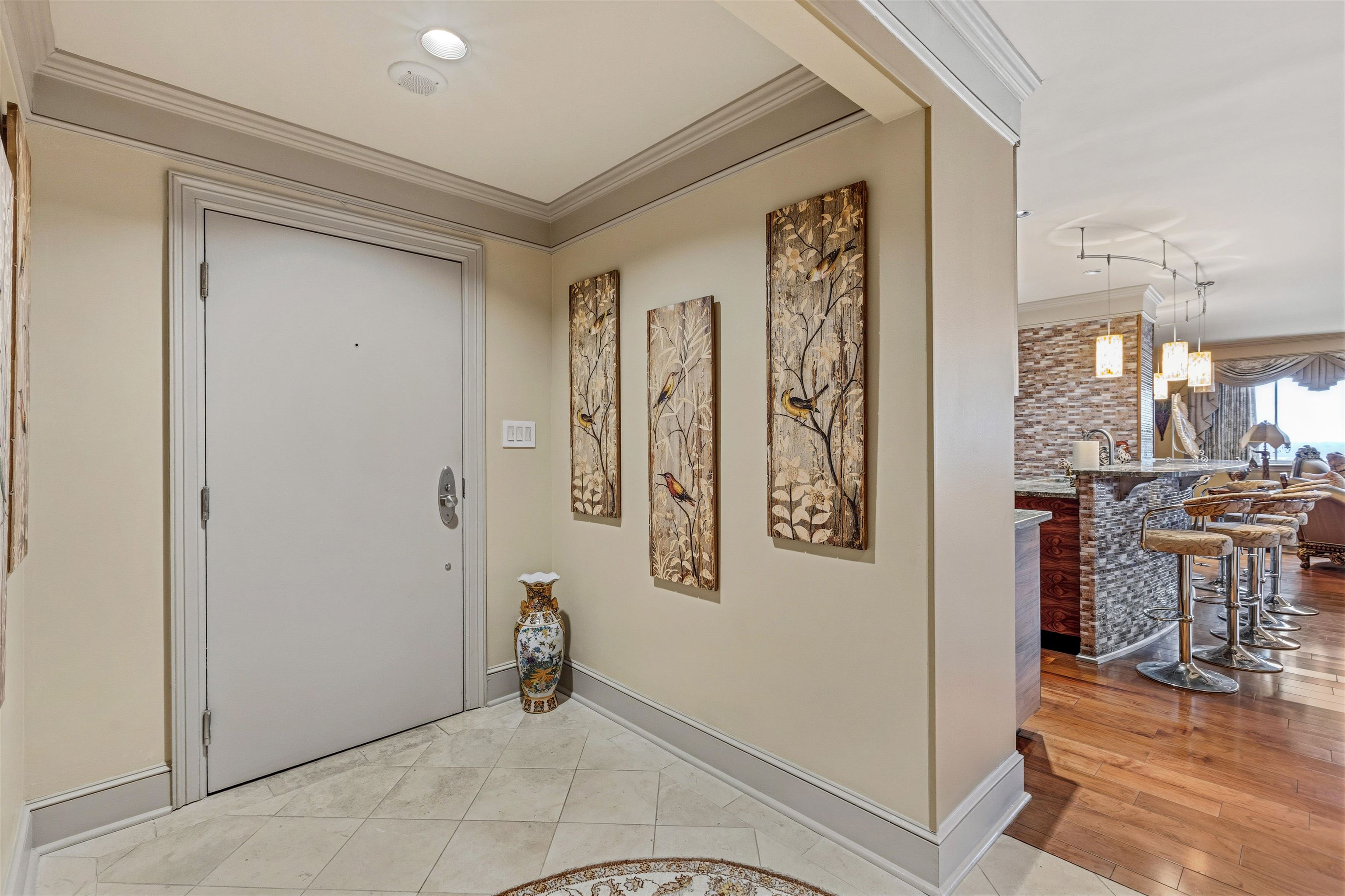 655 Riverside Drive, Unit 1208 Memphis, TN 38103 - Photo 6 of 29 Foyer featuring ornamental molding and light wood finished floors