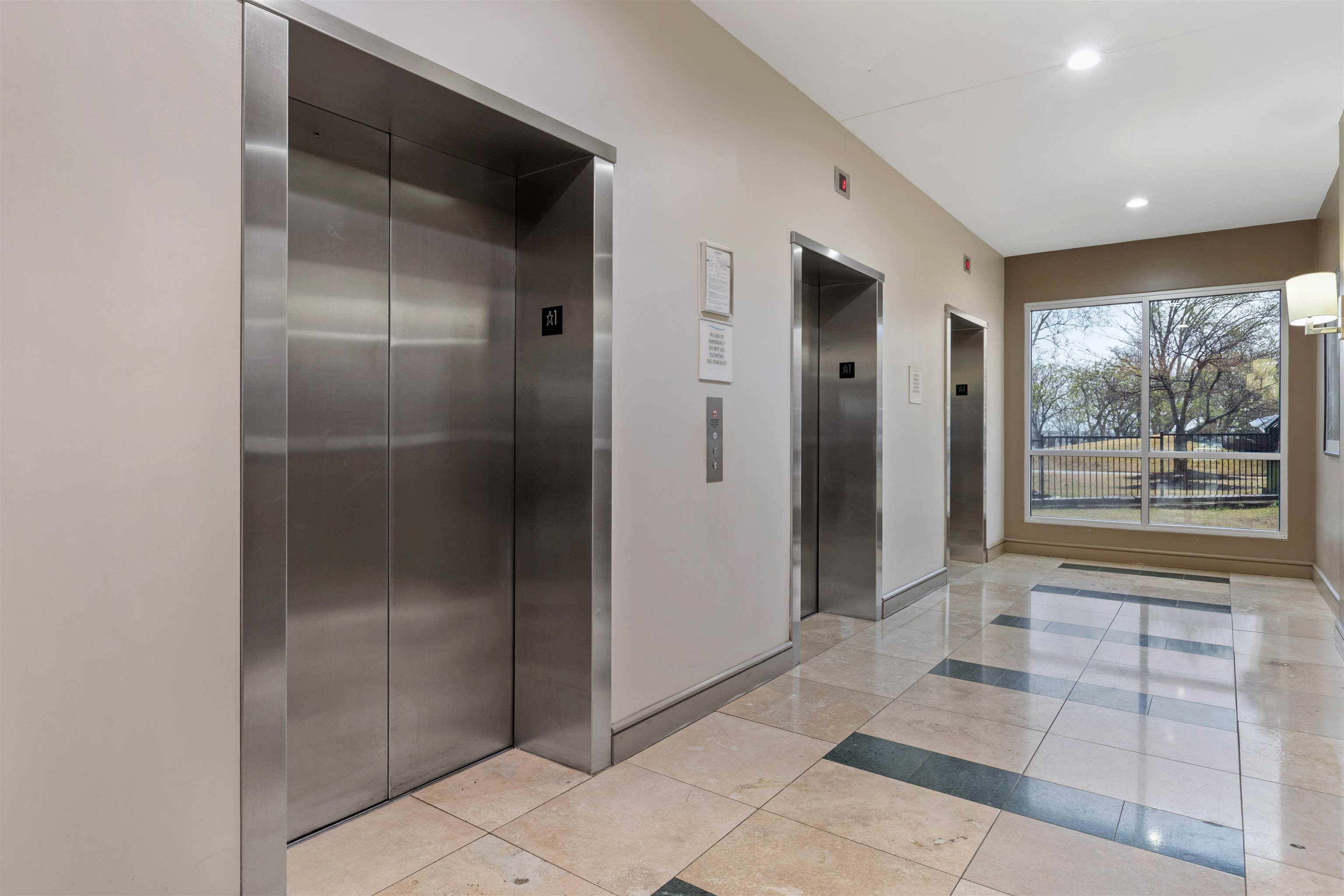 655 Riverside Drive, Unit 1208 Memphis, TN 38103 - Photo 9 of 29 Corridor with elevator, recessed lighting, and light tile patterned floors