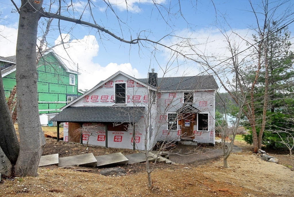 66 Pine Point Road Stow, MA 01775 - Photo 3 of 25 a front view of a house with garden