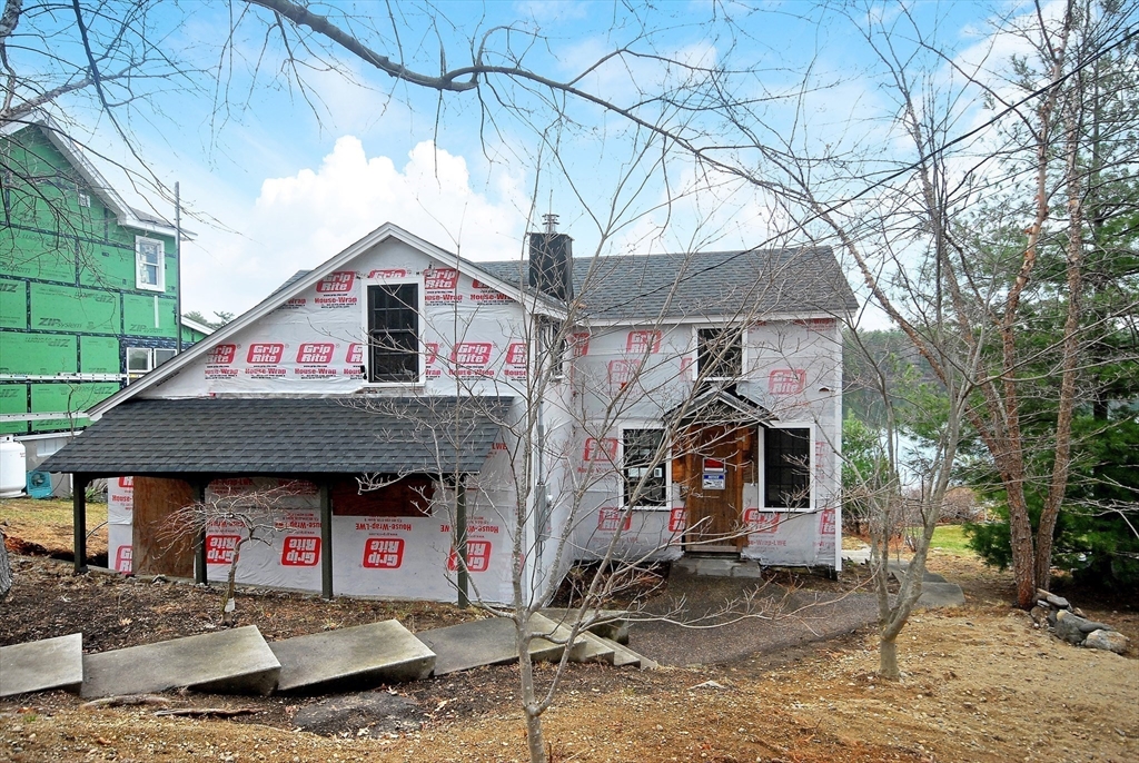 66 Pine Point Road Stow, MA 01775 - Photo 6 of 25 a front view of a house with a patio