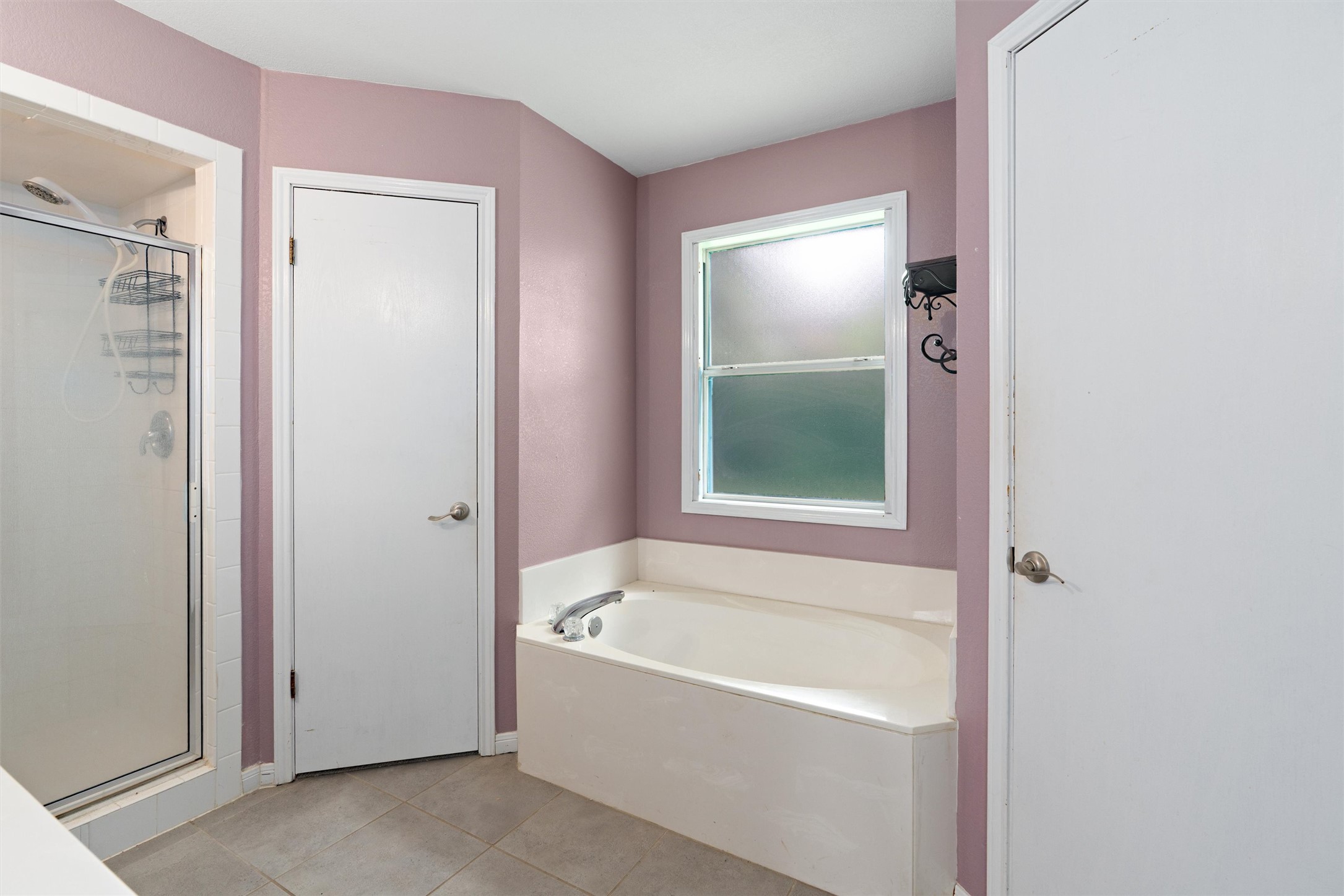 2306 Raintree Path Round Rock, TX 78664 - Photo 17 of 23 Indulge in a tranquil bathing experience with this deep soaking tub and adjacent walk-in shower.