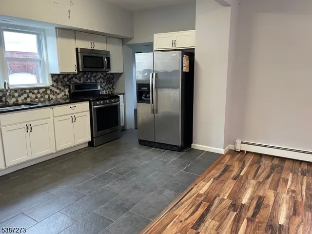 a kitchen with a refrigerator stove and sink