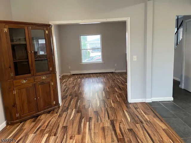a view of a room with wooden floor and stairs