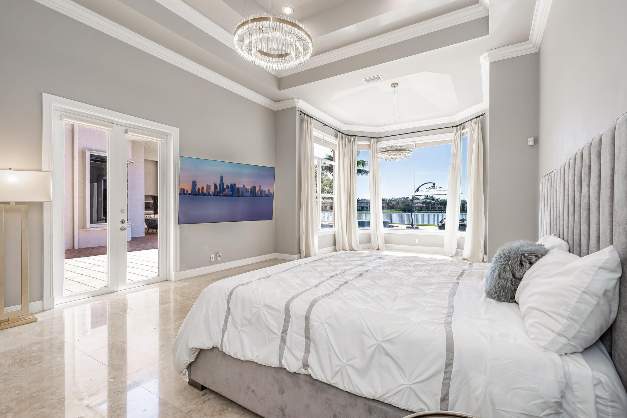 3111 Lake Ridge Lane Weston, FL 33332 - Photo 11 of 21 a bedroom with a large bed and a large mirror with dresser