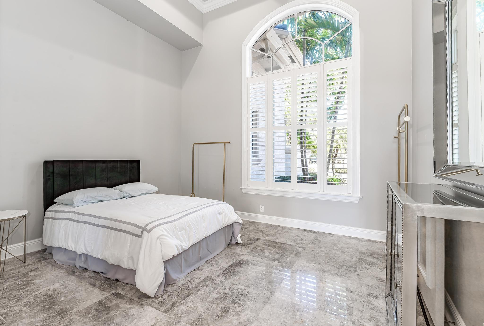 3111 Lake Ridge Lane Weston, FL 33332 - Photo 15 of 21 a bedroom with a bed and a window