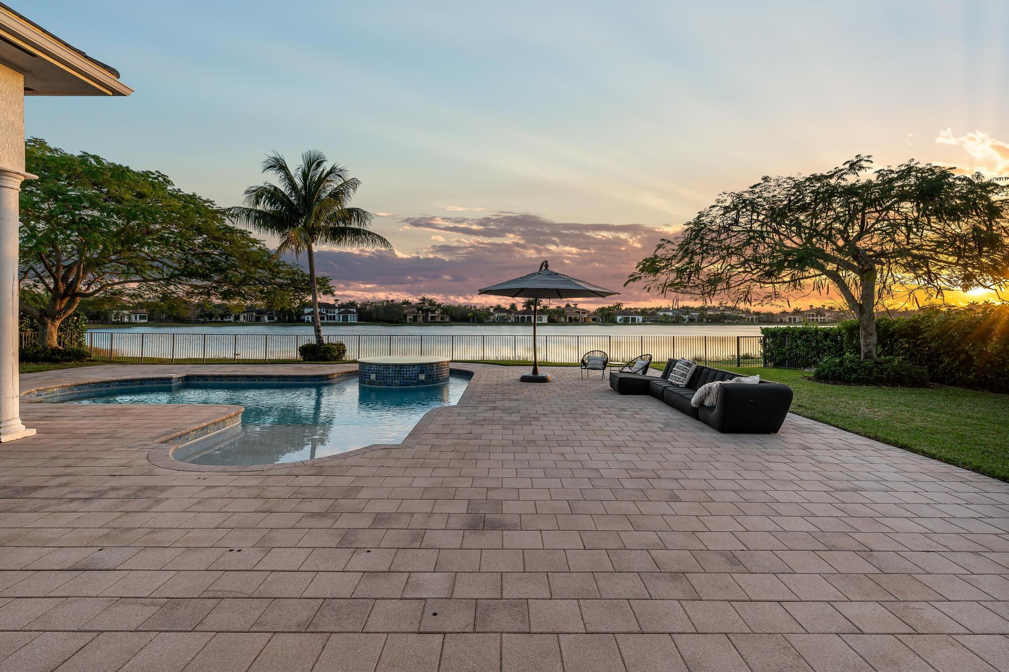 3111 Lake Ridge Lane Weston, FL 33332 - Photo 18 of 21 a view of swimming pool with a table and chair under an umbrella