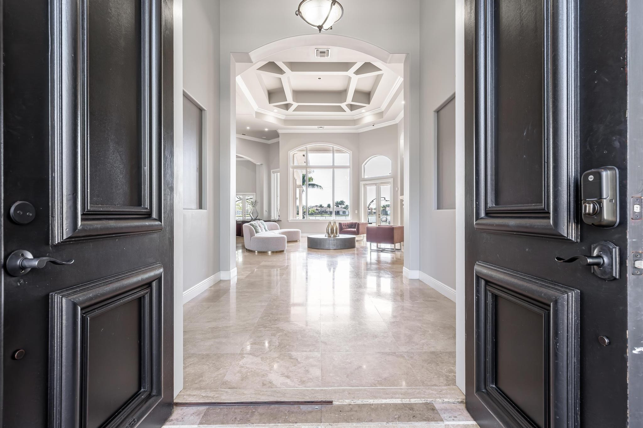 3111 Lake Ridge Lane Weston, FL 33332 - Photo 5 of 21 a view of a living room with a fireplace a chandelier and windows