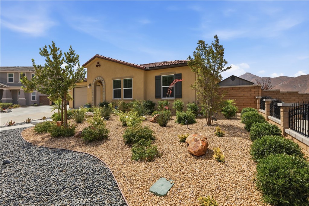 21159 Blue Jeans Court Riverside, CA 92507 - Photo 8 of 63 a front view of a house with a yard