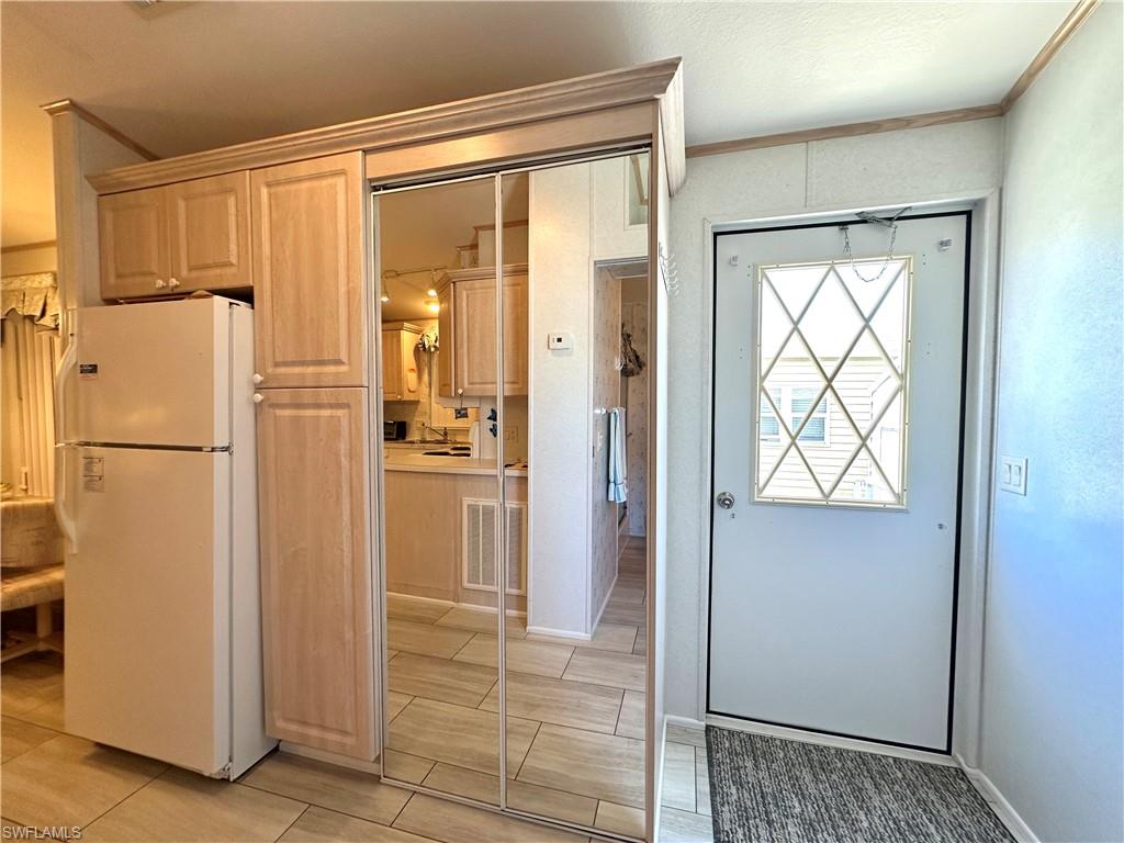 4540 Split Log Lane East Estero, FL 33928 - Photo 11 of 15 a view of kitchen with furniture and refrigerator