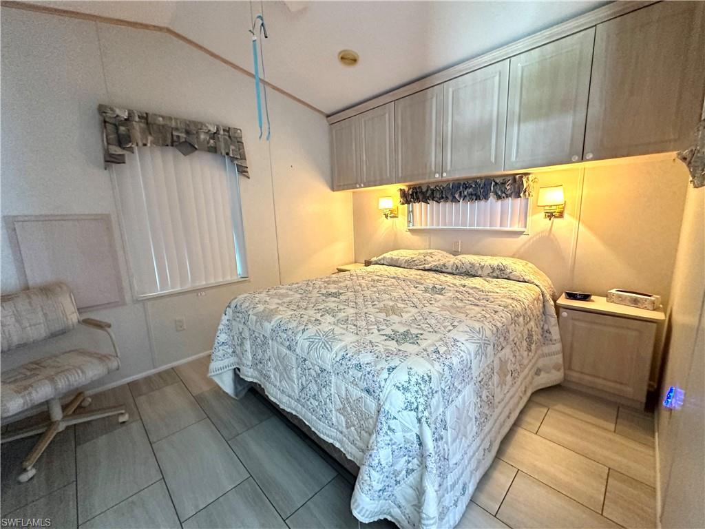 4540 Split Log Lane East Estero, FL 33928 - Photo 12 of 15 a bedroom with a bed and a couch