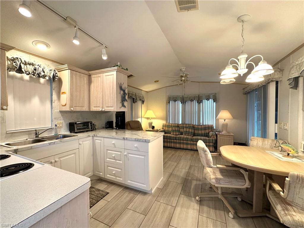 4540 Split Log Lane East Estero, FL 33928 - Photo 5 of 15 a kitchen with a sink appliances and cabinets