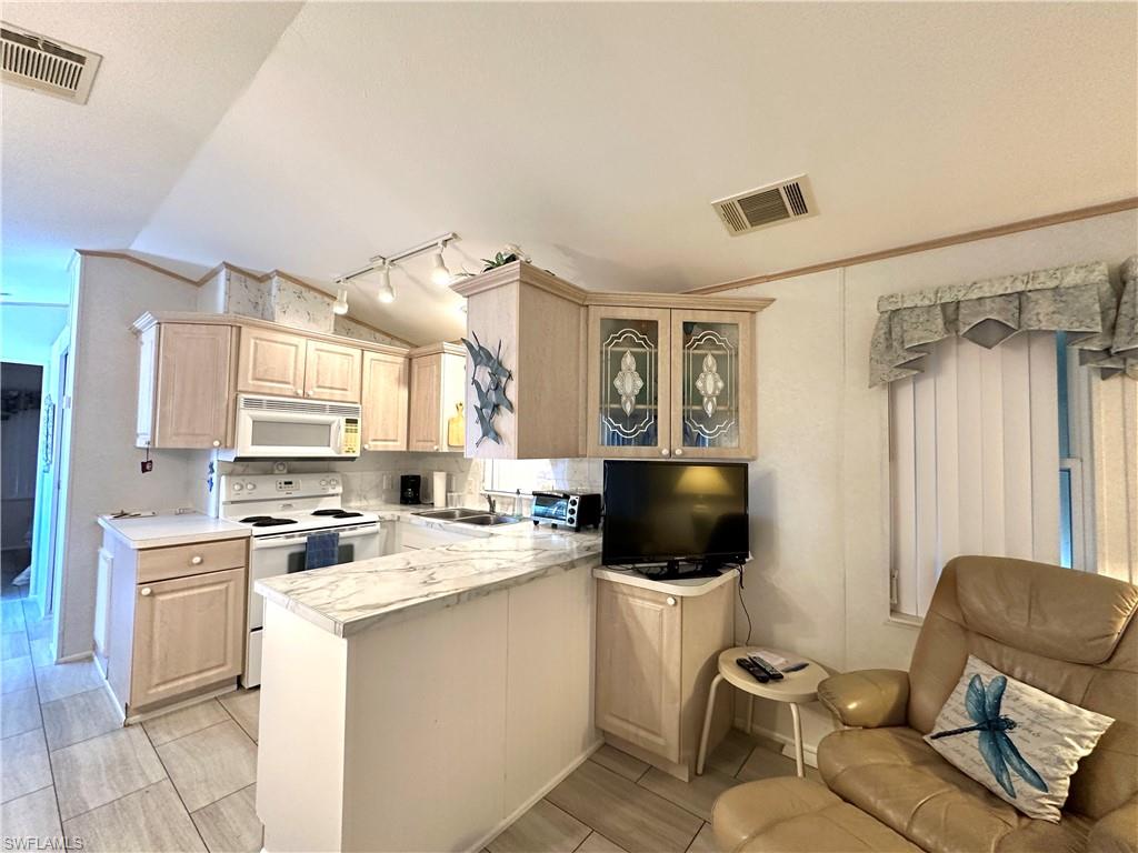 4540 Split Log Lane East Estero, FL 33928 - Photo 6 of 15 a kitchen with a sink cabinets and a window