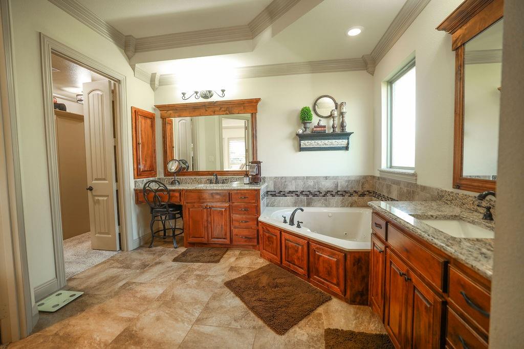 1387 Shadow Lakes Drive Wills Point, TX 75169 - Photo 14 of 30 Primary Bathroom with crown molding, two vanities, and a jetted tub
