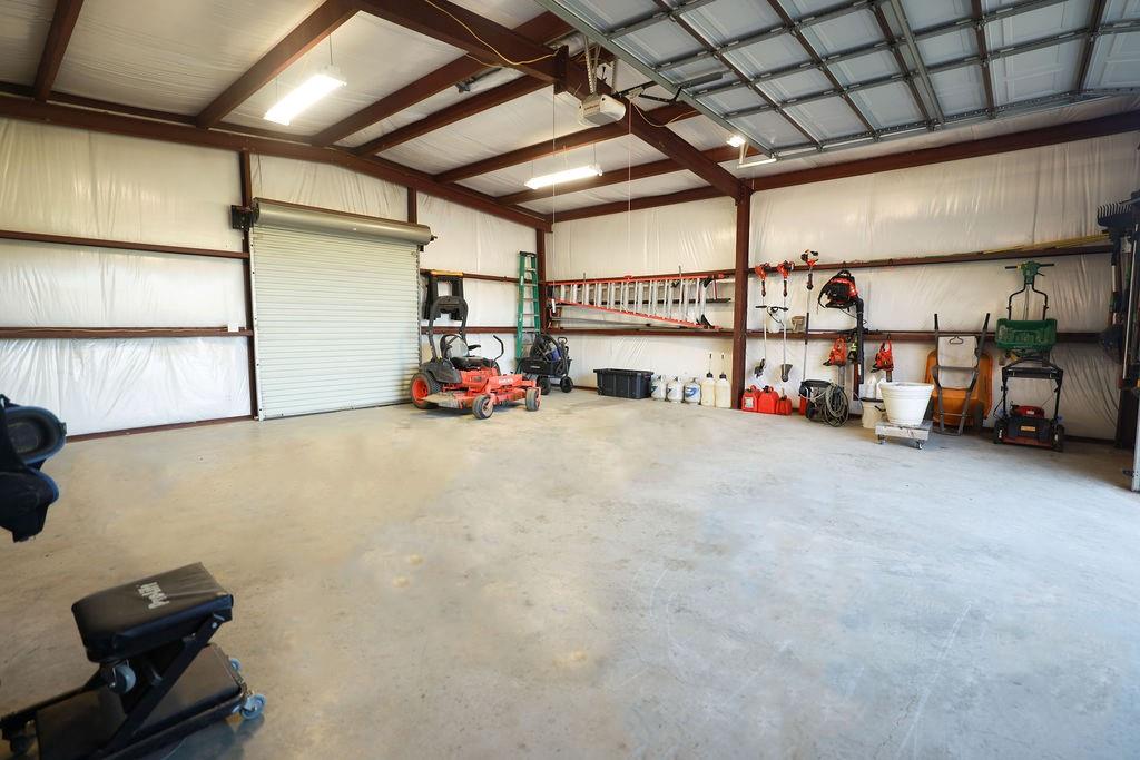 1387 Shadow Lakes Drive Wills Point, TX 75169 - Photo 22 of 30 Garage featuring a garage door opener