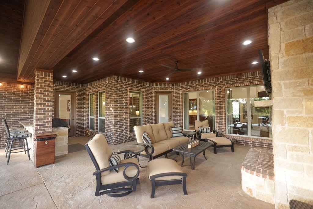 1387 Shadow Lakes Drive Wills Point, TX 75169 - Photo 23 of 30 View of patio / terrace featuring an outdoor living space and a ceiling fan, fire place, tv, outdoor kitchen
