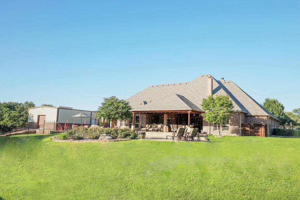 1387 Shadow Lakes Drive Wills Point, TX 75169 - Photo 27 of 30 Rear view of property with a patio and brick siding