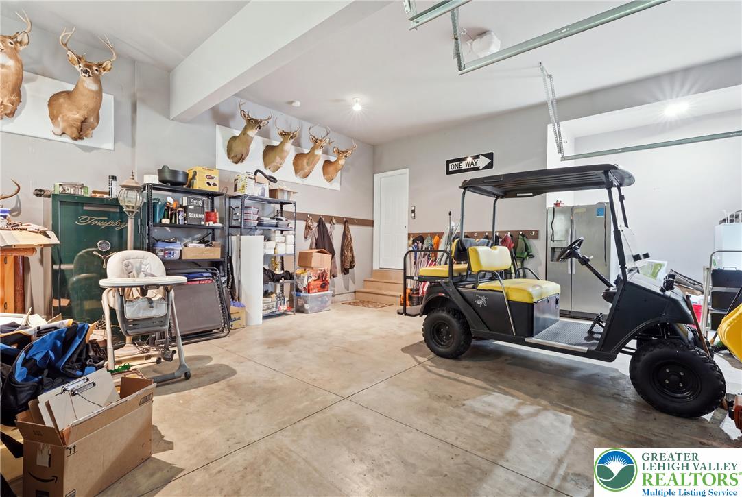 245 East Dell Road Bath, PA 18014 - Photo 78 of 99 A spacious, clean garage offers ample storage and utility, featuring direct access to the interior of the home.