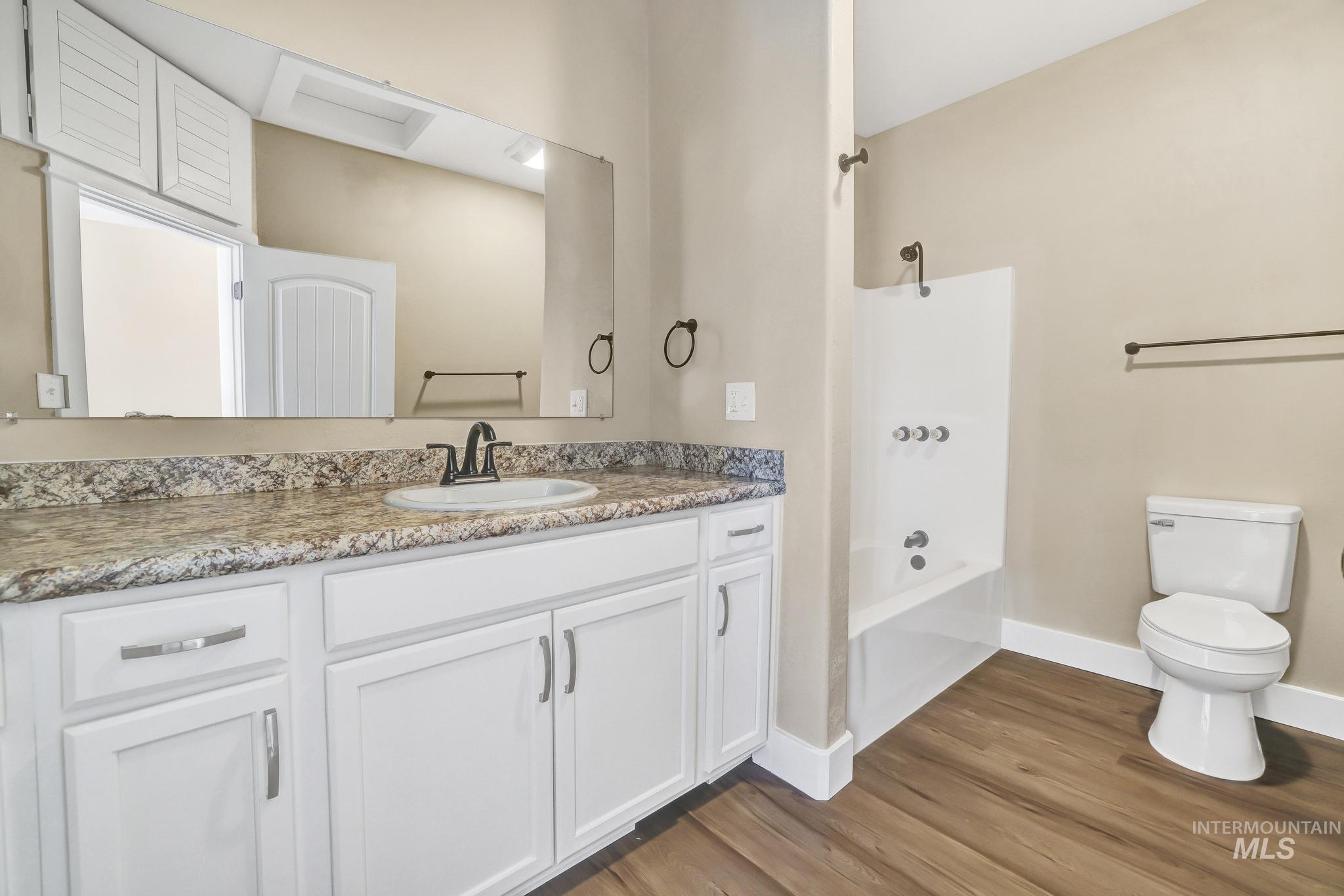1226 Washington Street Gooding, ID 83330 - Photo 11 of 13 Full bath with vanity, shower / bath combination, and light wood-style floors