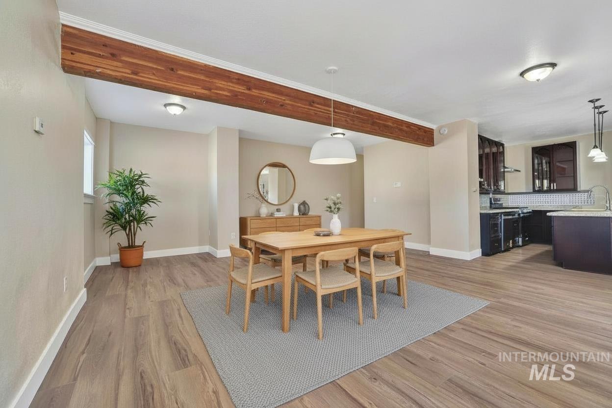 1226 Washington Street Gooding, ID 83330 - Photo 2 of 13 Dining area featuring light wood finished floors and beam ceiling