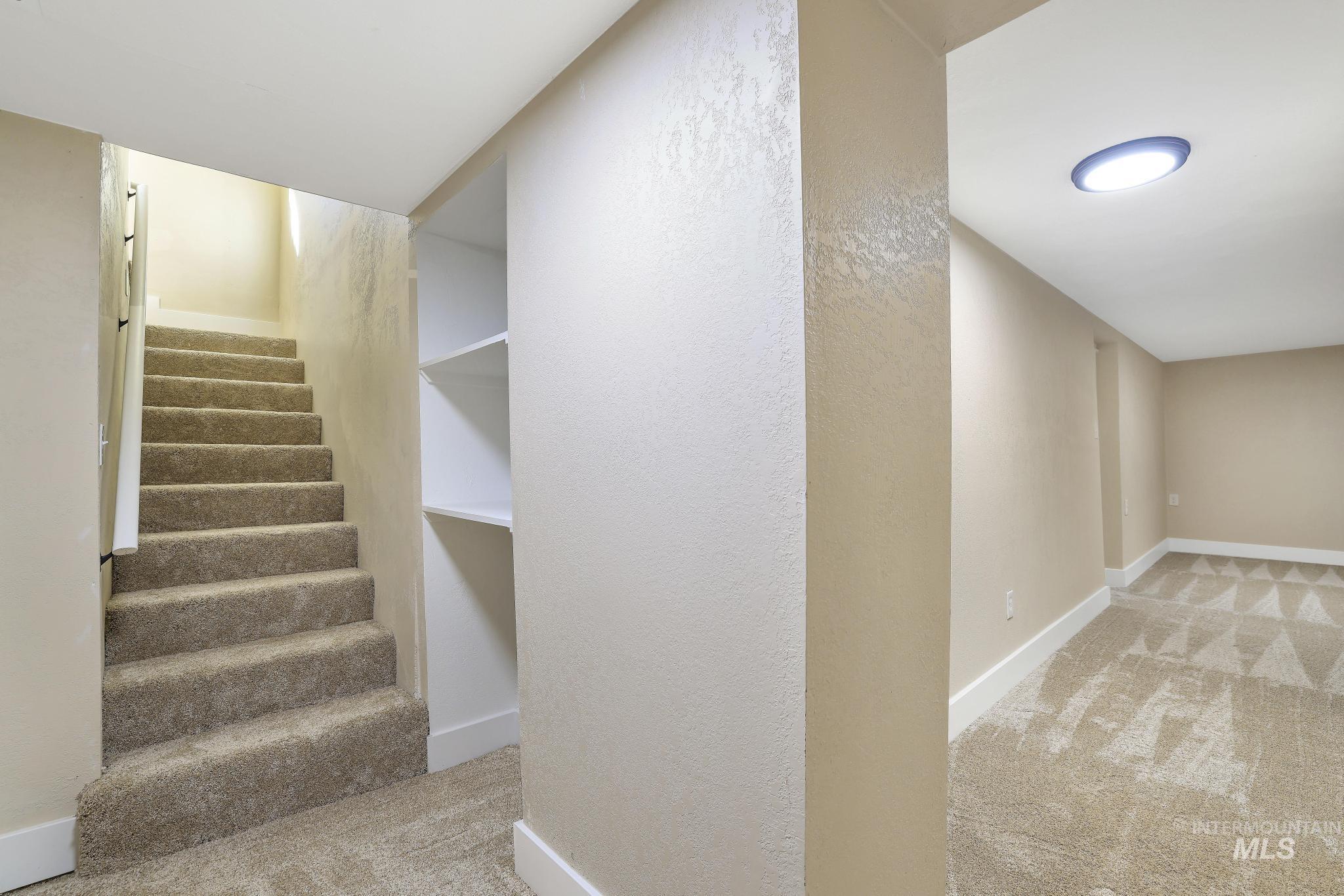 1226 Washington Street Gooding, ID 83330 - Photo 7 of 13 Stairs featuring carpet floors and a textured wall