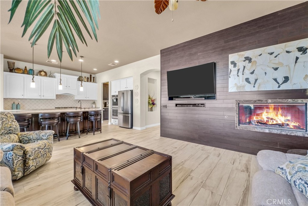 45407 Callesito Altar Temecula, CA 92592 - Photo 14 of 47 a living room with stainless steel appliances kitchen island granite countertop furniture and a flat screen tv