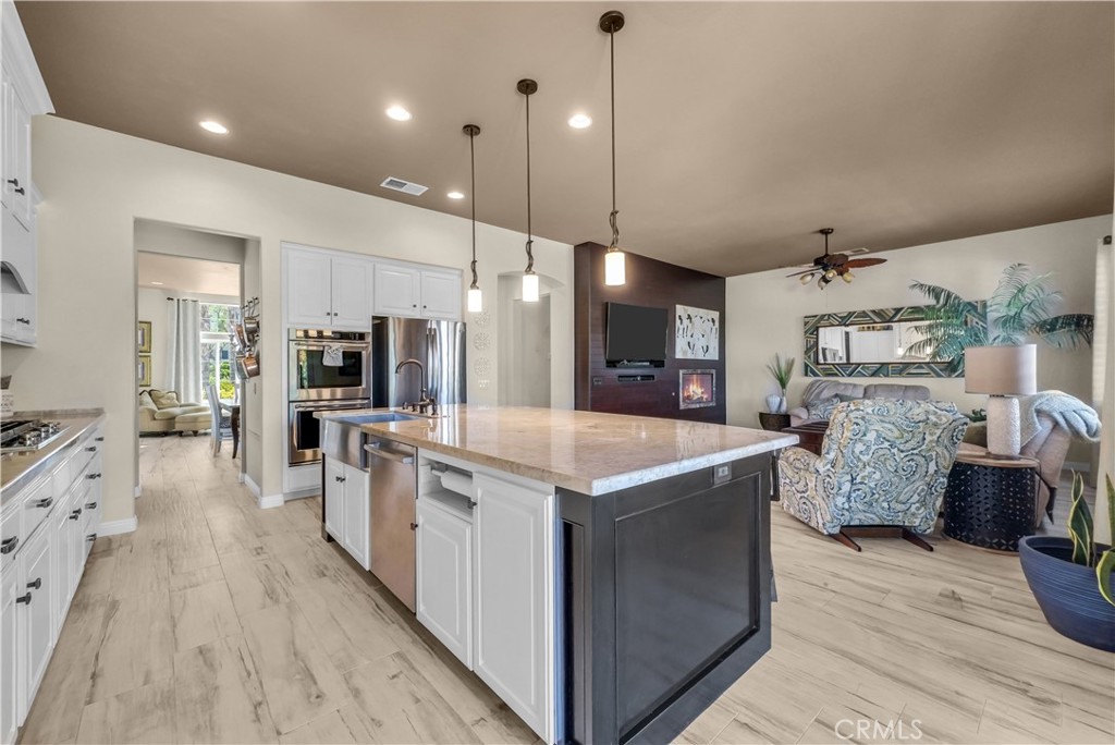 45407 Callesito Altar Temecula, CA 92592 - Photo 15 of 47 a large kitchen with stainless steel appliances kitchen island granite countertop a large counter top and stove