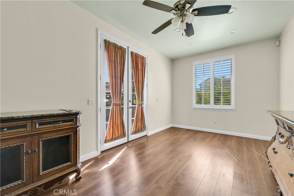 45407 Callesito Altar Temecula, CA 92592 - Photo 18 of 47 an empty room with wooden floor a ceiling fan and windows