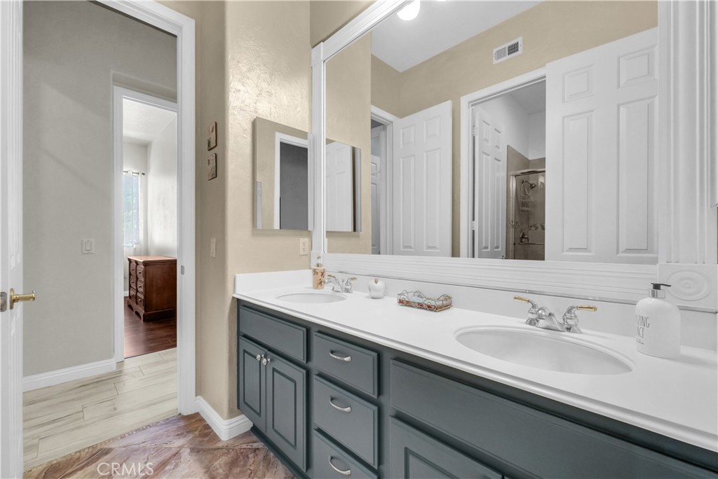 45407 Callesito Altar Temecula, CA 92592 - Photo 19 of 47 a bathroom with a double vanity sink and a mirror