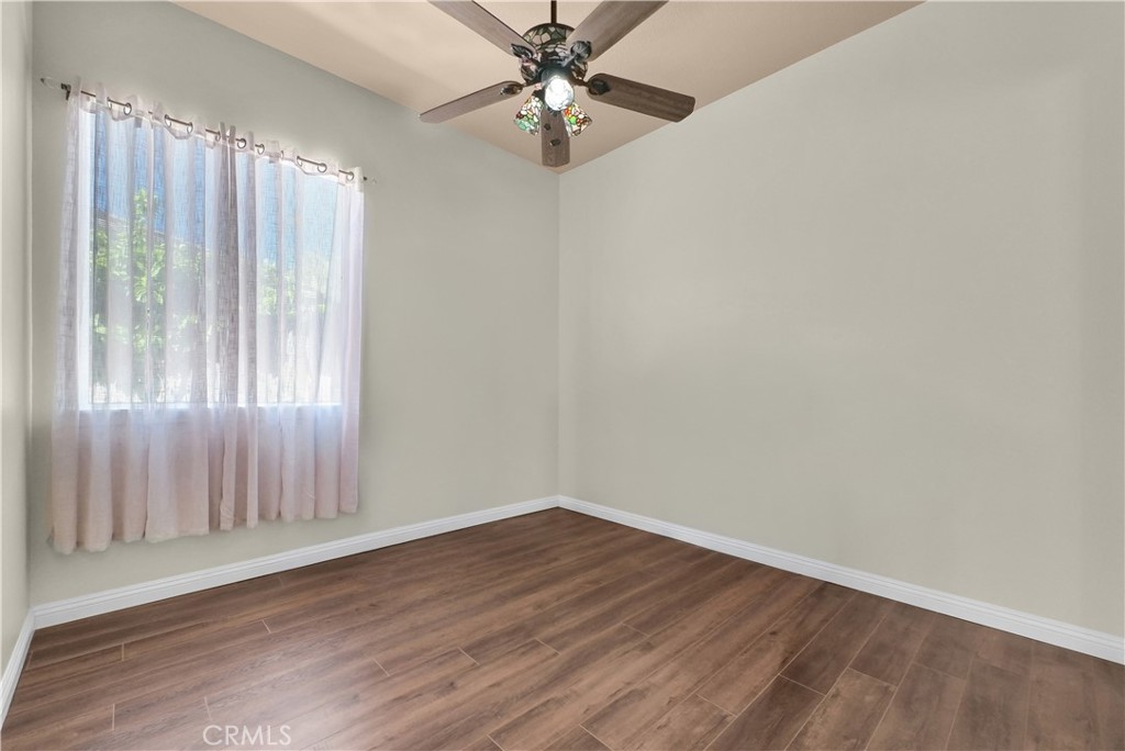 45407 Callesito Altar Temecula, CA 92592 - Photo 22 of 47 an empty room with wooden floor fan and windows
