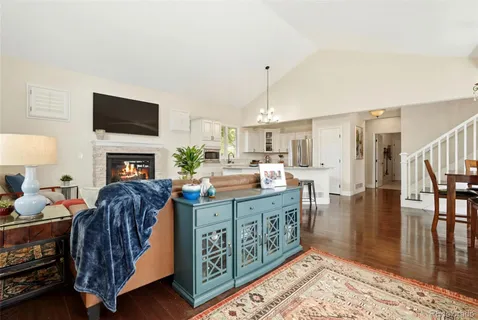 a living room with fireplace furniture and a flat screen tv