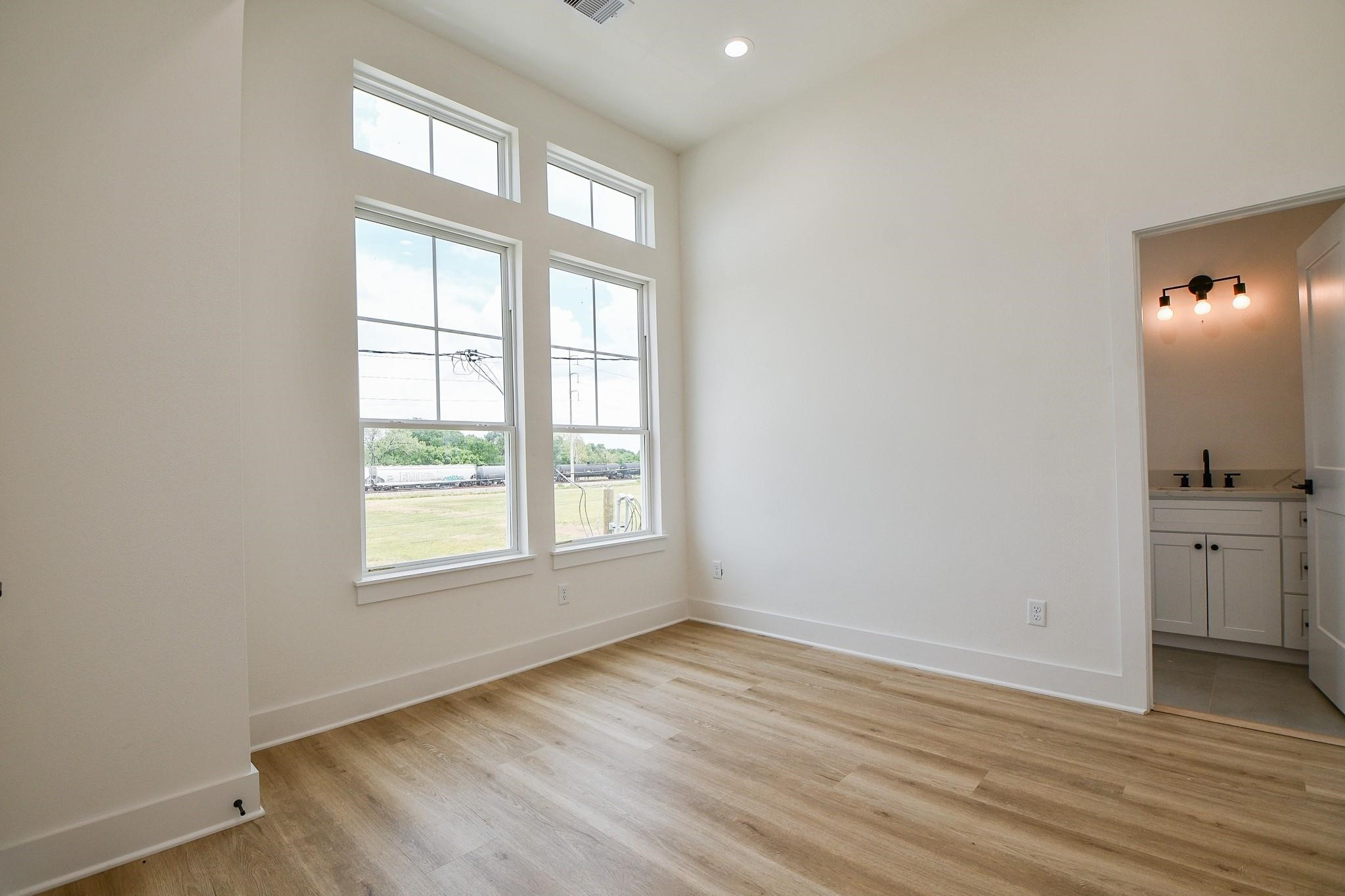 2305 Maury Street Houston, TX 77026 - Photo 14 of 19 an empty room with wooden floor and windows