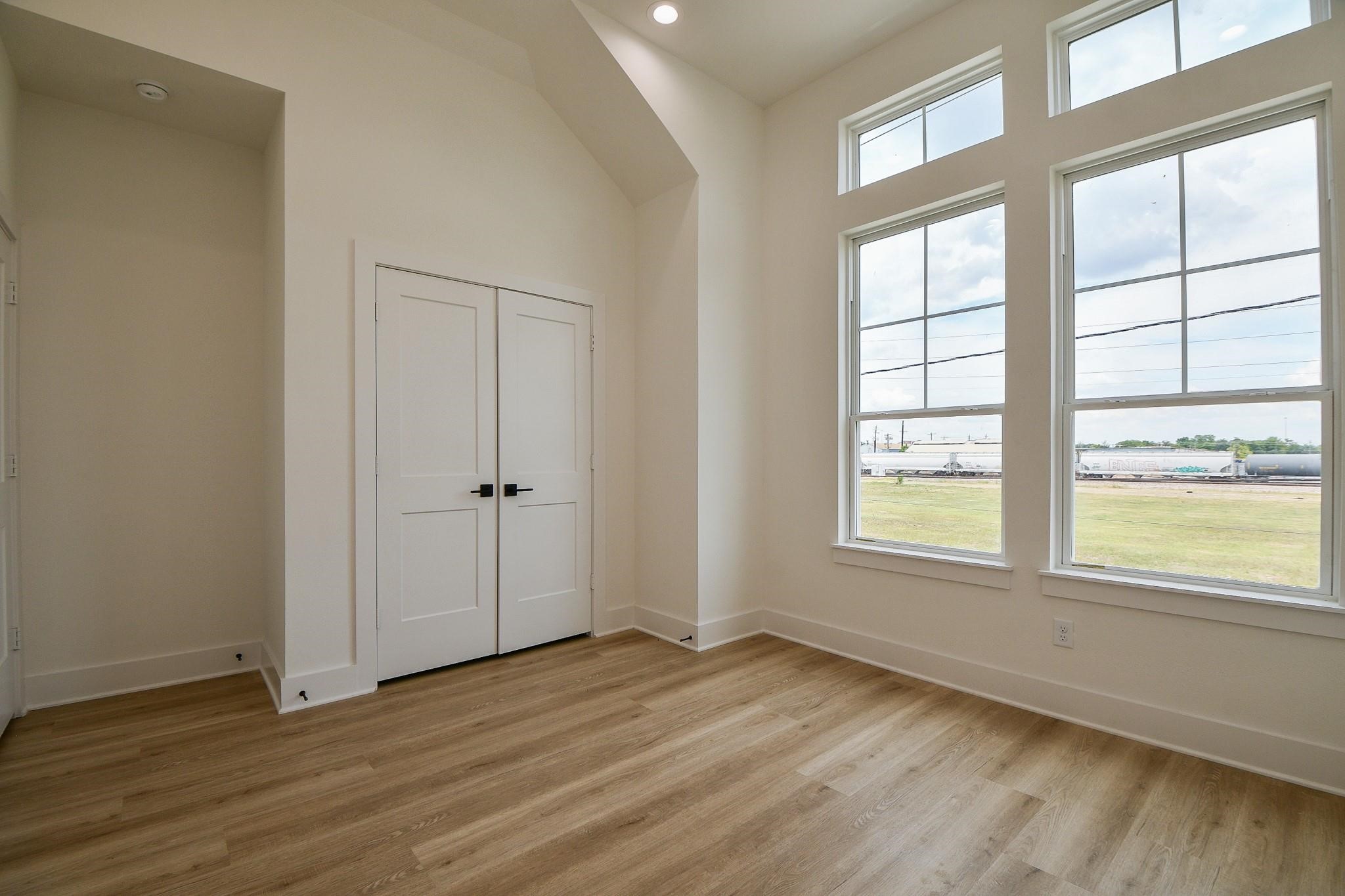 2305 Maury Street Houston, TX 77026 - Photo 16 of 19 an empty room with wooden floor and windows