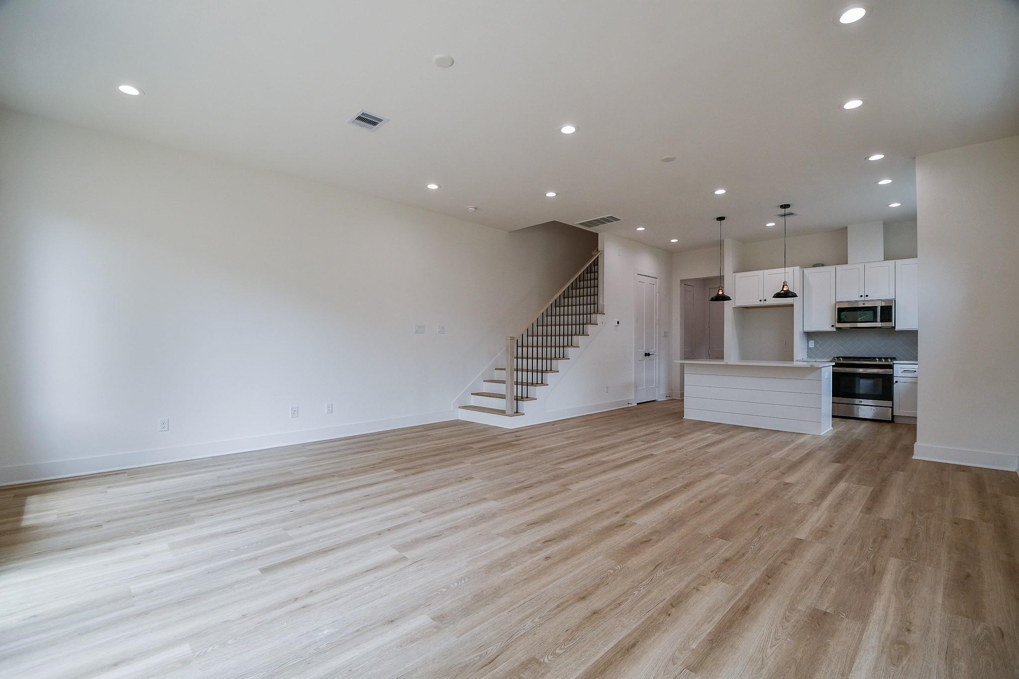 2305 Maury Street Houston, TX 77026 - Photo 5 of 19 a view of kitchen and hall with wooden floor