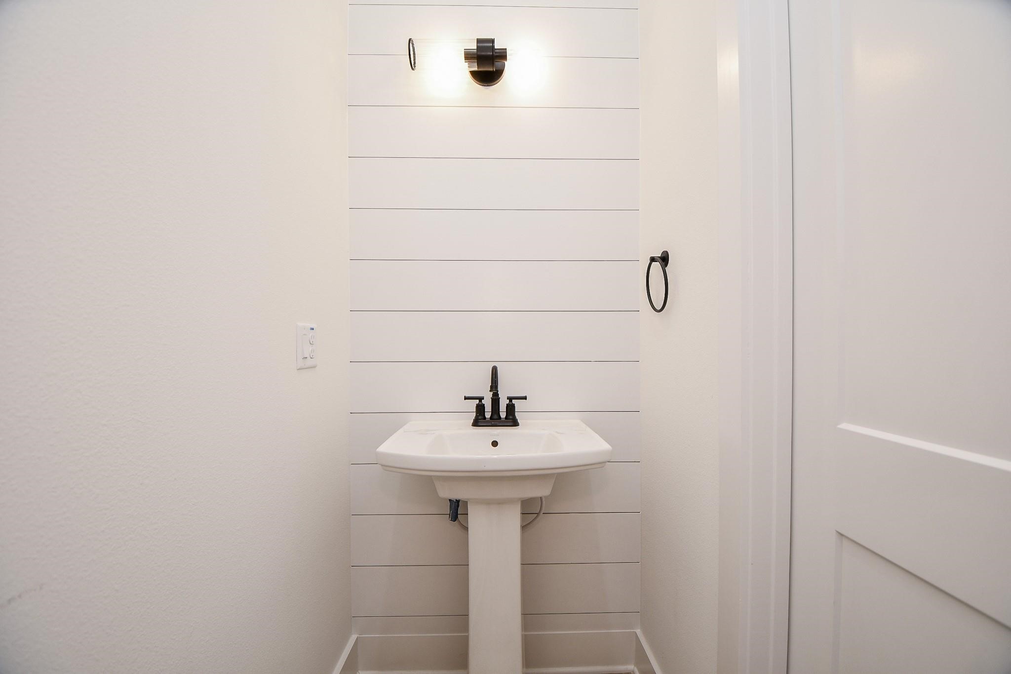2305 Maury Street Houston, TX 77026 - Photo 7 of 19 a bathroom with a sink a mirror and shower