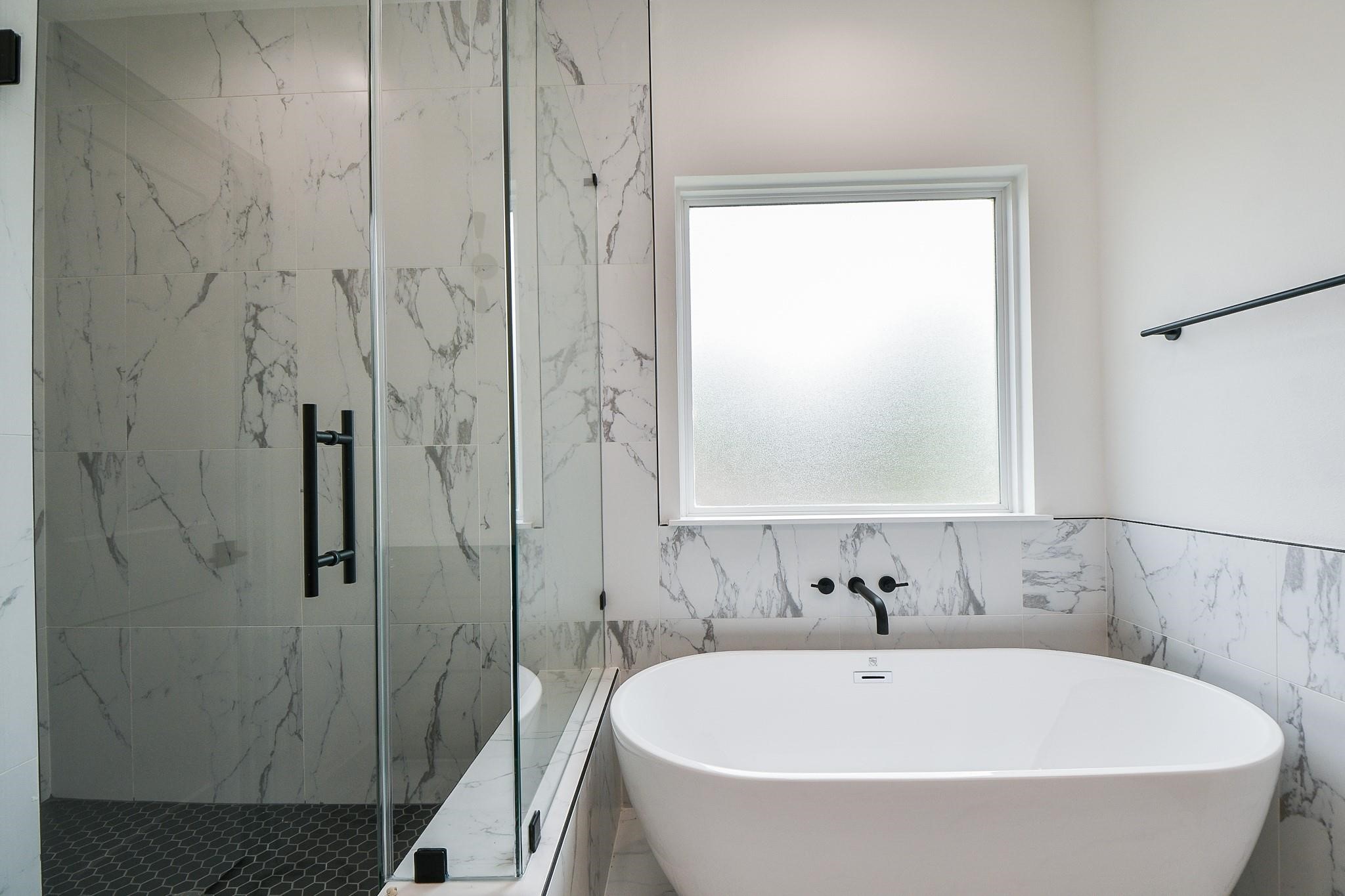 2305 Maury Street Houston, TX 77026 - Photo 10 of 19 a white bath tub sitting next to a white sink