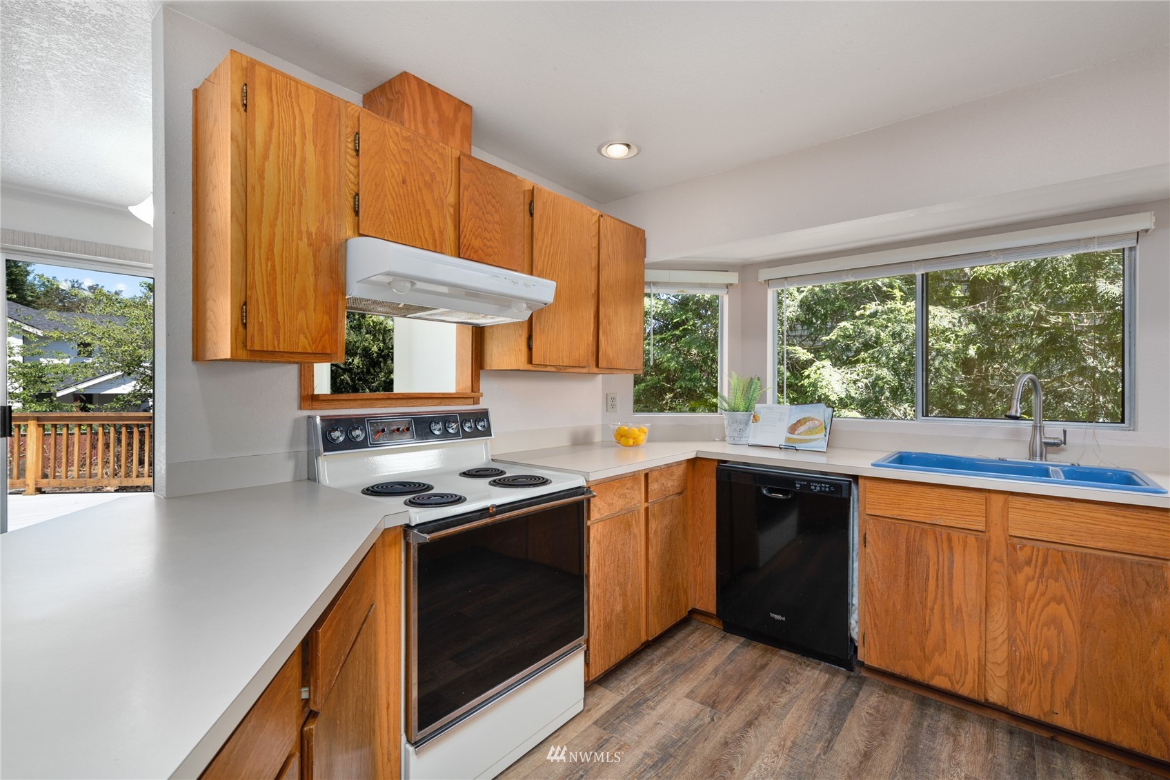 813 226th Street Southeast Bothell, WA 98021 - Photo 11 of 30 a kitchen with stainless steel appliances granite countertop wooden cabinets a stove a sink and a large window