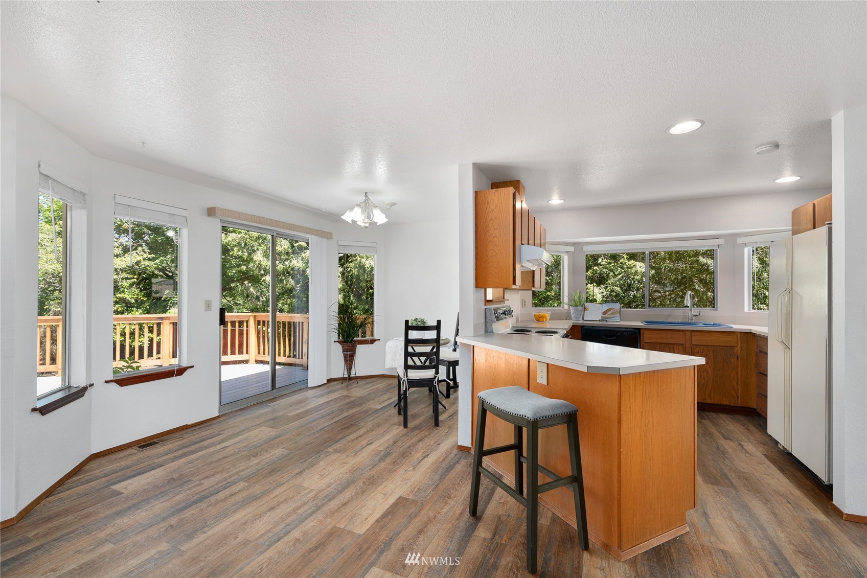 813 226th Street Southeast Bothell, WA 98021 - Photo 14 of 30 a view of a dining room with furniture window and wooden floor