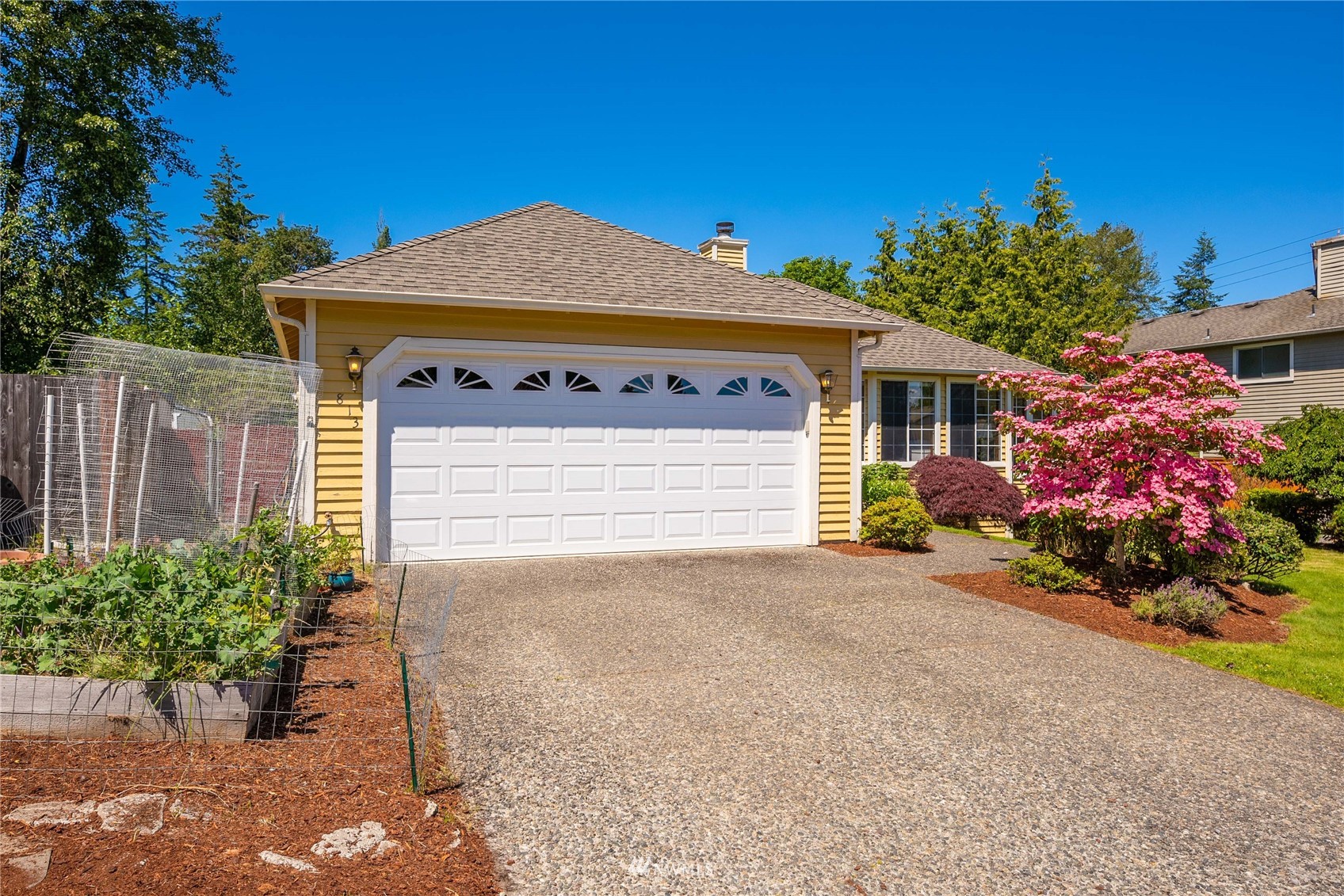 813 226th Street Southeast Bothell, WA 98021 - Photo 2 of 30 a front view of a house with a yard and a garage