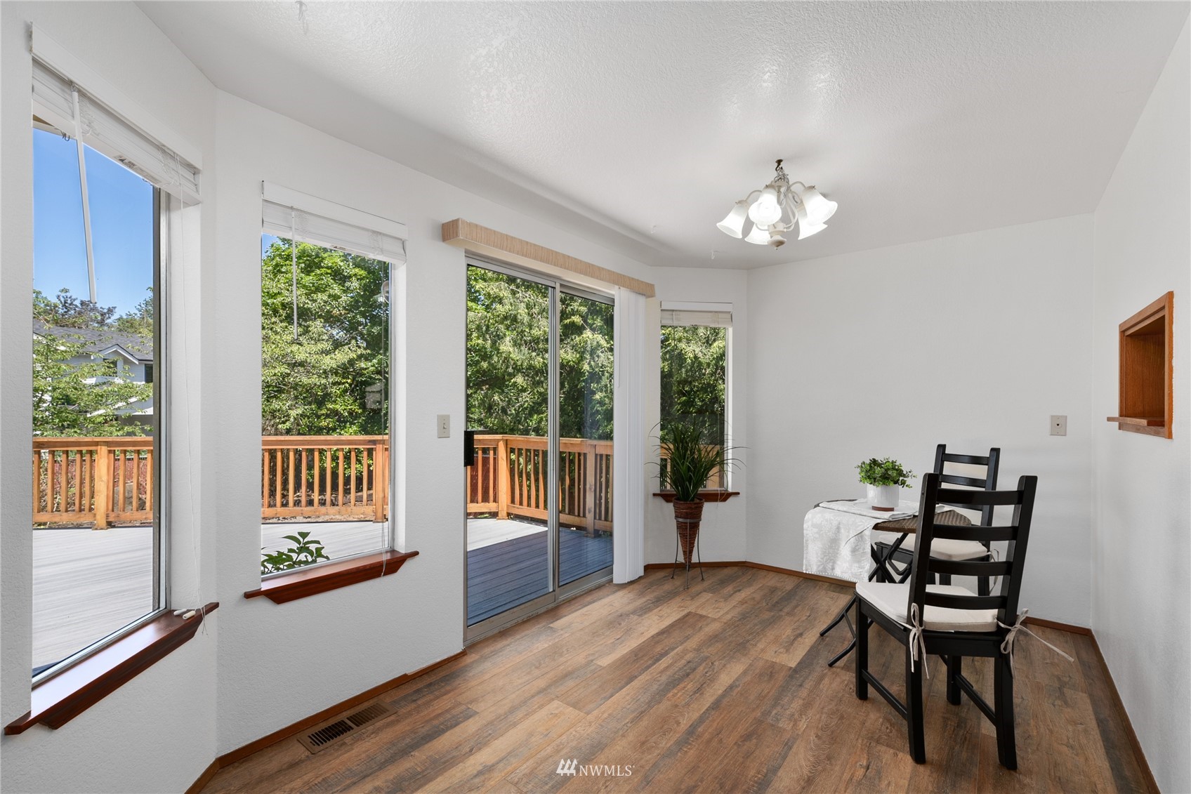813 226th Street Southeast Bothell, WA 98021 - Photo 24 of 30 a view of a dining room with furniture a chandelier and wooden floor