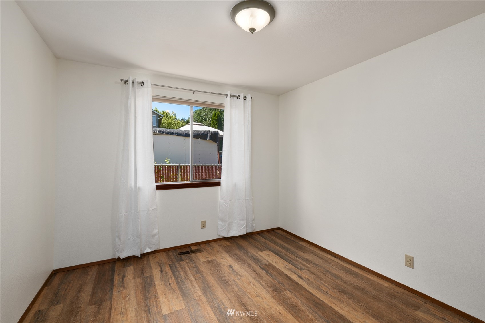 813 226th Street Southeast Bothell, WA 98021 - Photo 25 of 30 a view of an empty room with wooden floor and a window