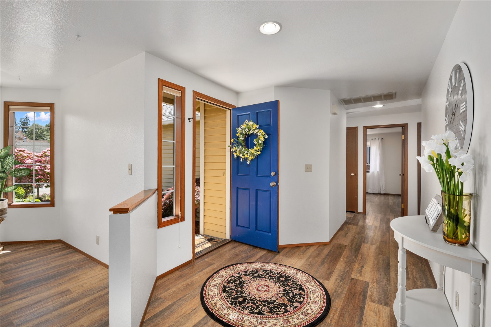 813 226th Street Southeast Bothell, WA 98021 - Photo 3 of 30 a view of an entryway with wooden floor and a bookshelf